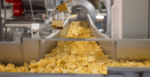 A conveyor belt transporting chips during the processing stage in a manufacturing facility.