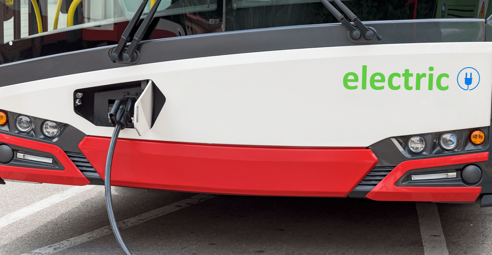 Electric bus charging at station.