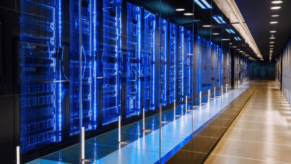 A long hallway with rows of servers in a data center, providing secure storage and processing capabilities.