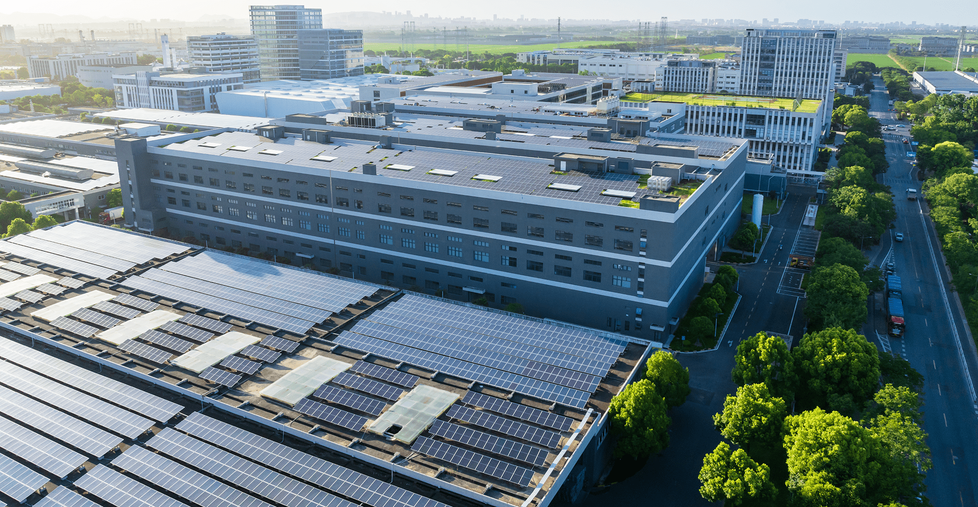 Aerial view of solar panels installed on a building's roof, showcasing renewable energy technology in urban architecture.