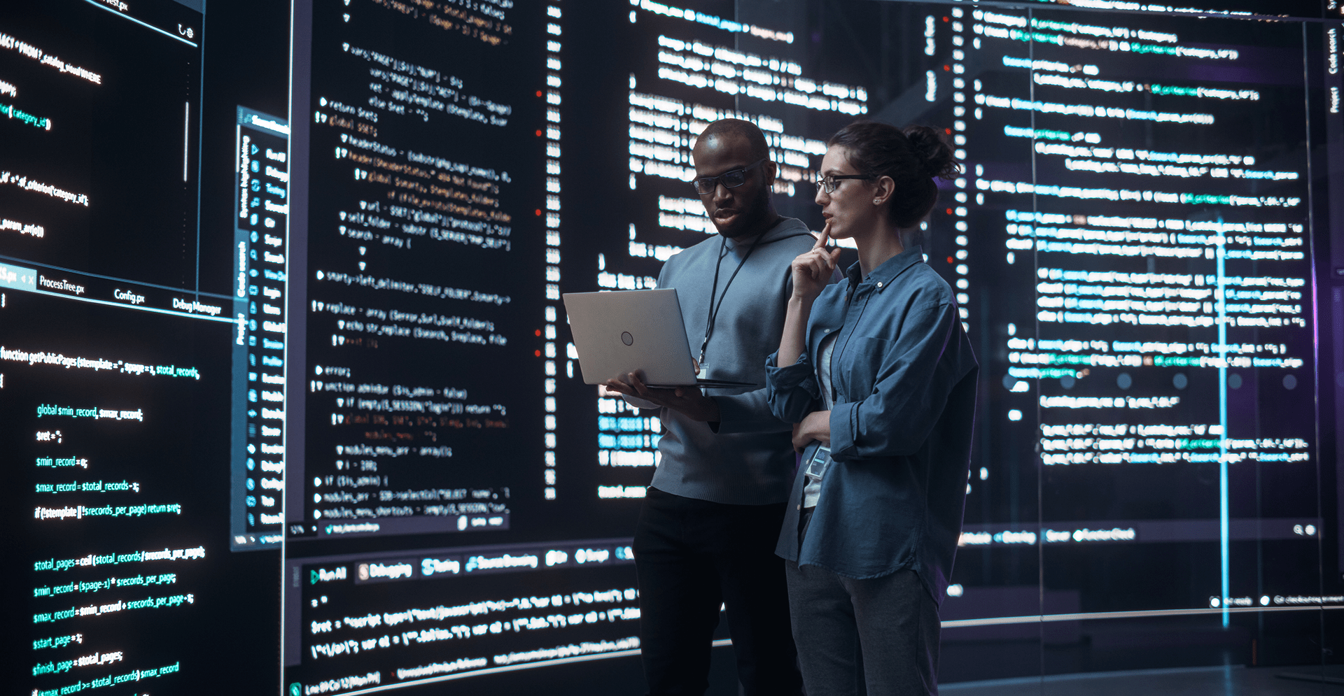 Developers analyzing code on large digital screens, highlighting software development, data analytics, and advanced technology collaboration.