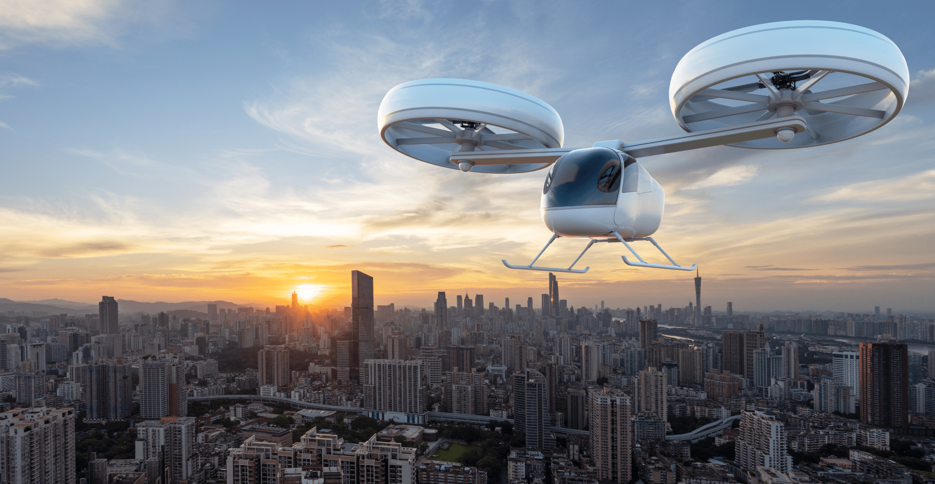 Aerial view of a drone soaring above a cityscape during sunset, capturing the urban landscape.