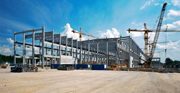 Large building being constructed with the help of cranes.