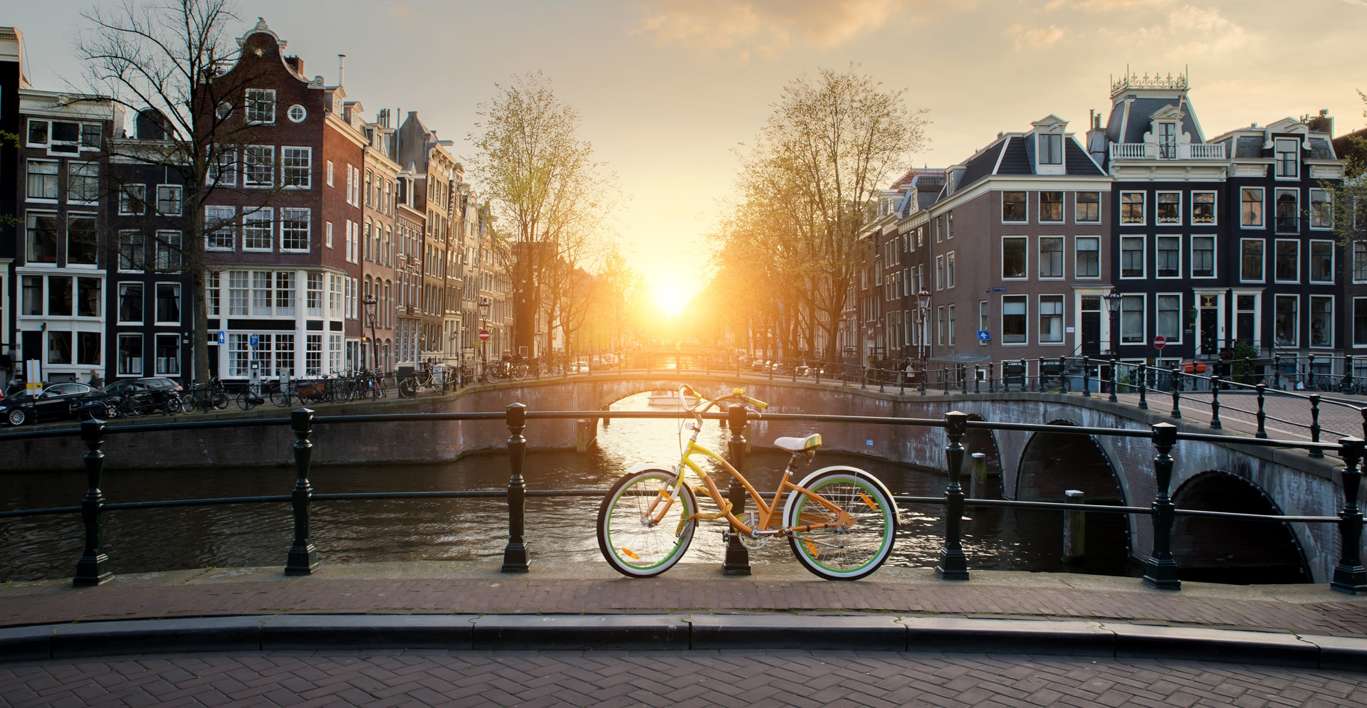 Bicycles lining a bridge over the canals of Amsterdam, Netherlands. Bicycle is major form of transportation in Amsterdam, Netherlands