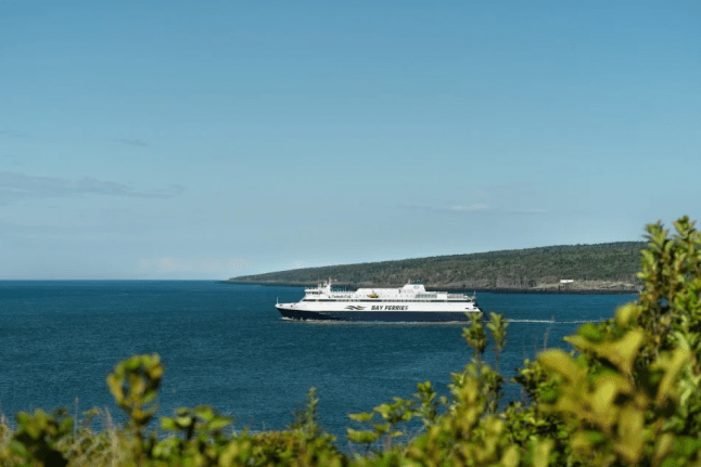 An image of the MV Fundy Rose passing by the Bay of Fundy.