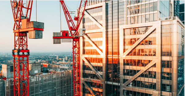 Construction crane positioned beside a building