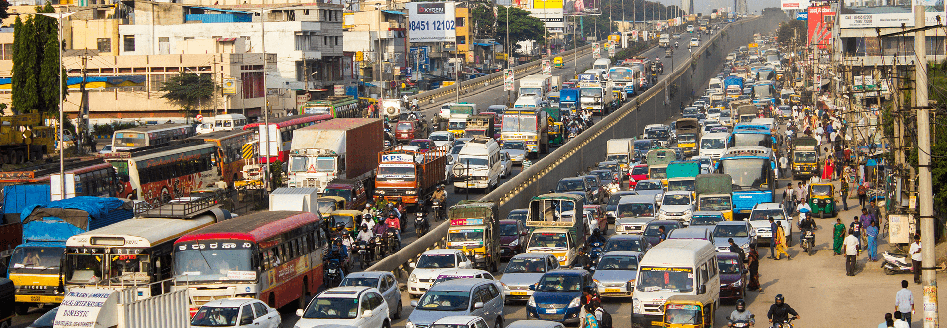  A bustling street filled with numerous cars and buses navigating through traffic.