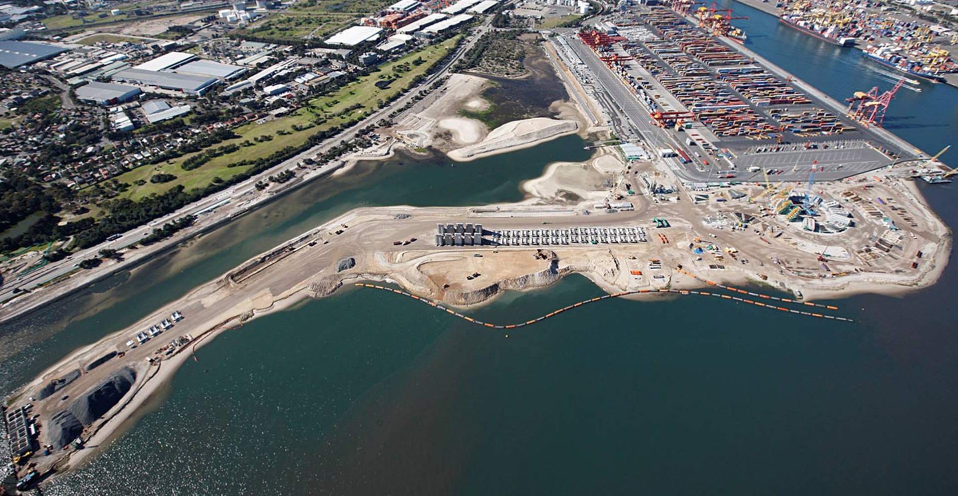 Aerial view of the Port, showcasing shipping containers, vessels, and construction.