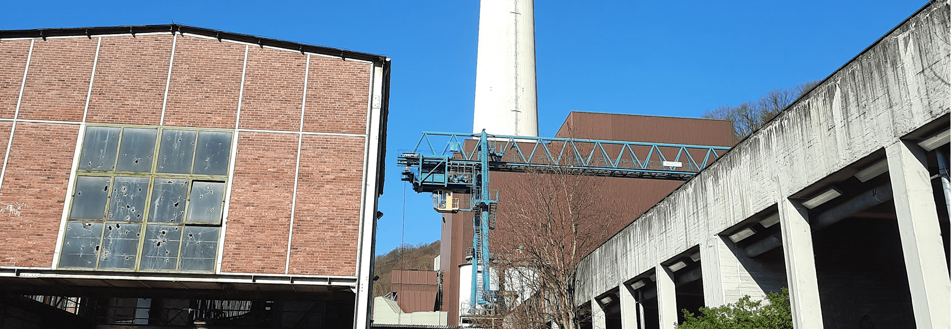 A building is framed by a clock tower in the background, showcasing a blend of historical architecture.