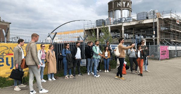 Crowd of people gathered outside a contemporary architectural landmark.