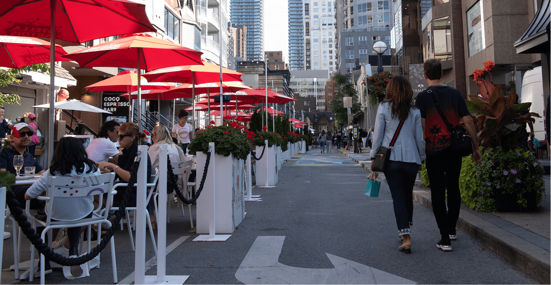People sitting outside at a CafeTO patio. 