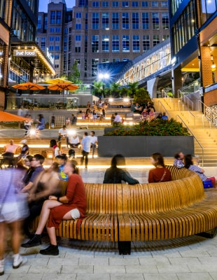 Atrium of a building with individuals seated outside, socializing.